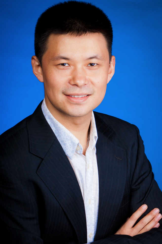 Alumnus David Ji Chen wearing a suit