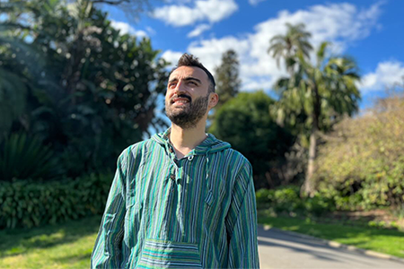 Hakki Azizoglu standing in a park.