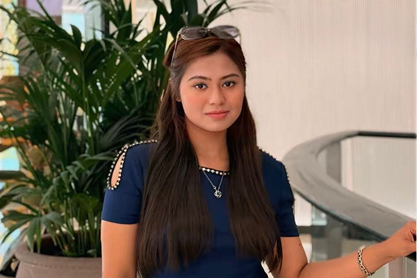 Shinthia Islam Juthi standing in front of potted plant