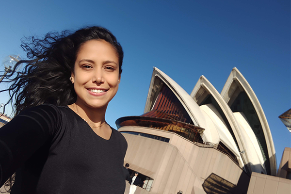 Leslie Paola Atencia Carvajal smiling with people in the background