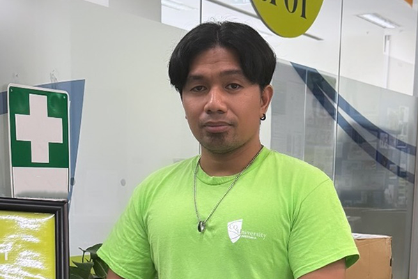 Ahl Anthony Galapon wearing a green CQUniversity shirt.