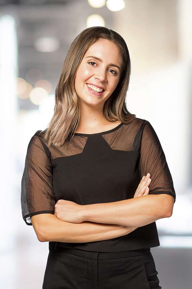 Hannah Thompson smiling with crossed arms