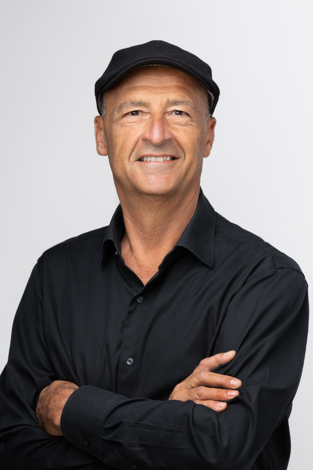 Alumnus Jerome Rivory wearing a shift and hat