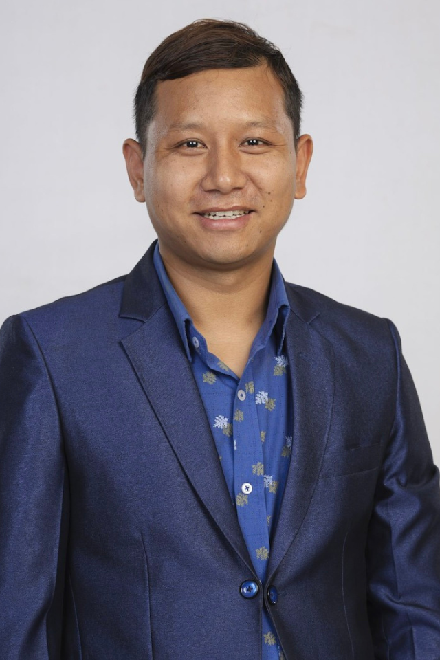 Alumnus Niraj Thapa Magar wearing a suit