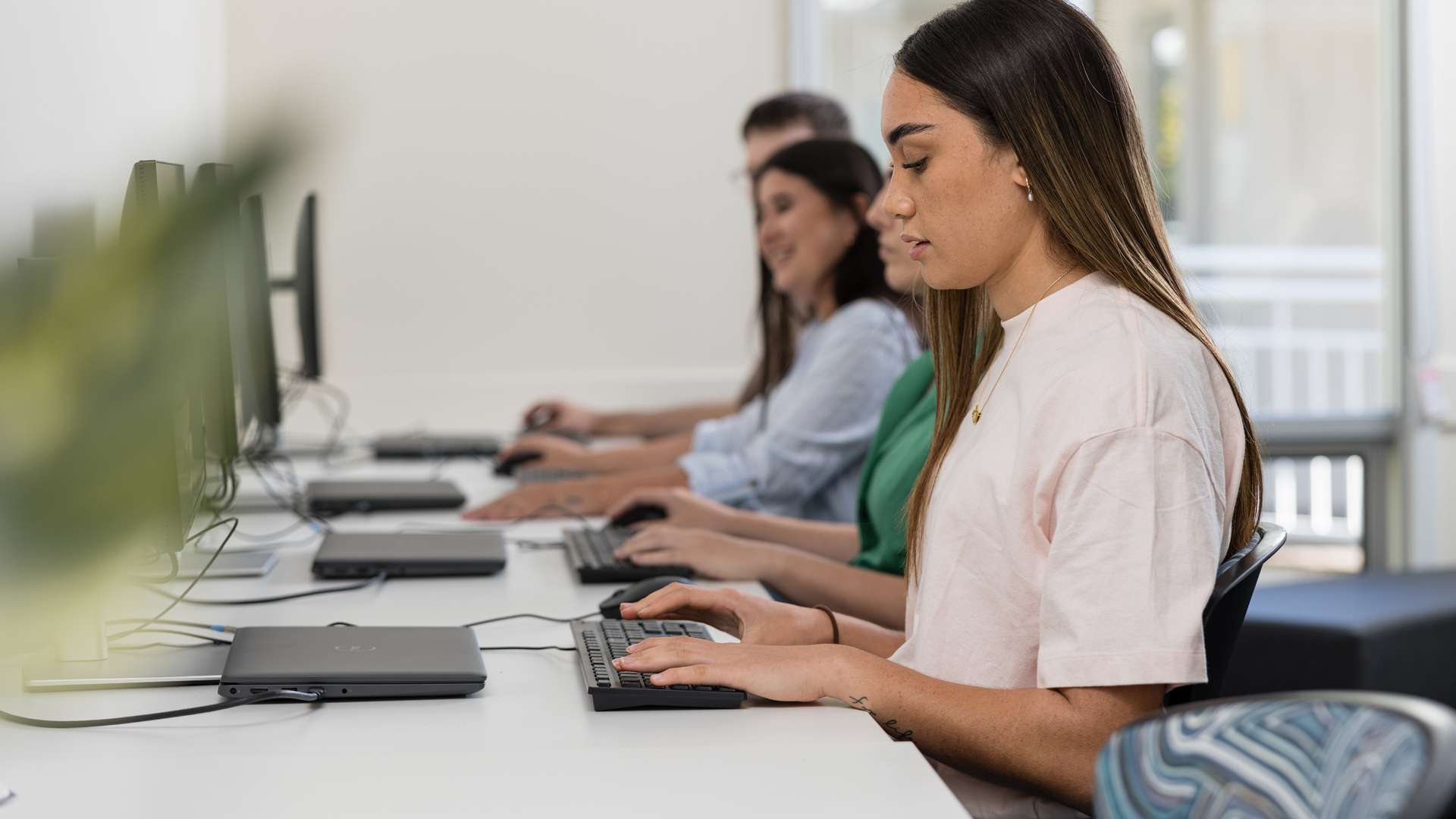 Four students working on computers in a classroom in Rockhampton