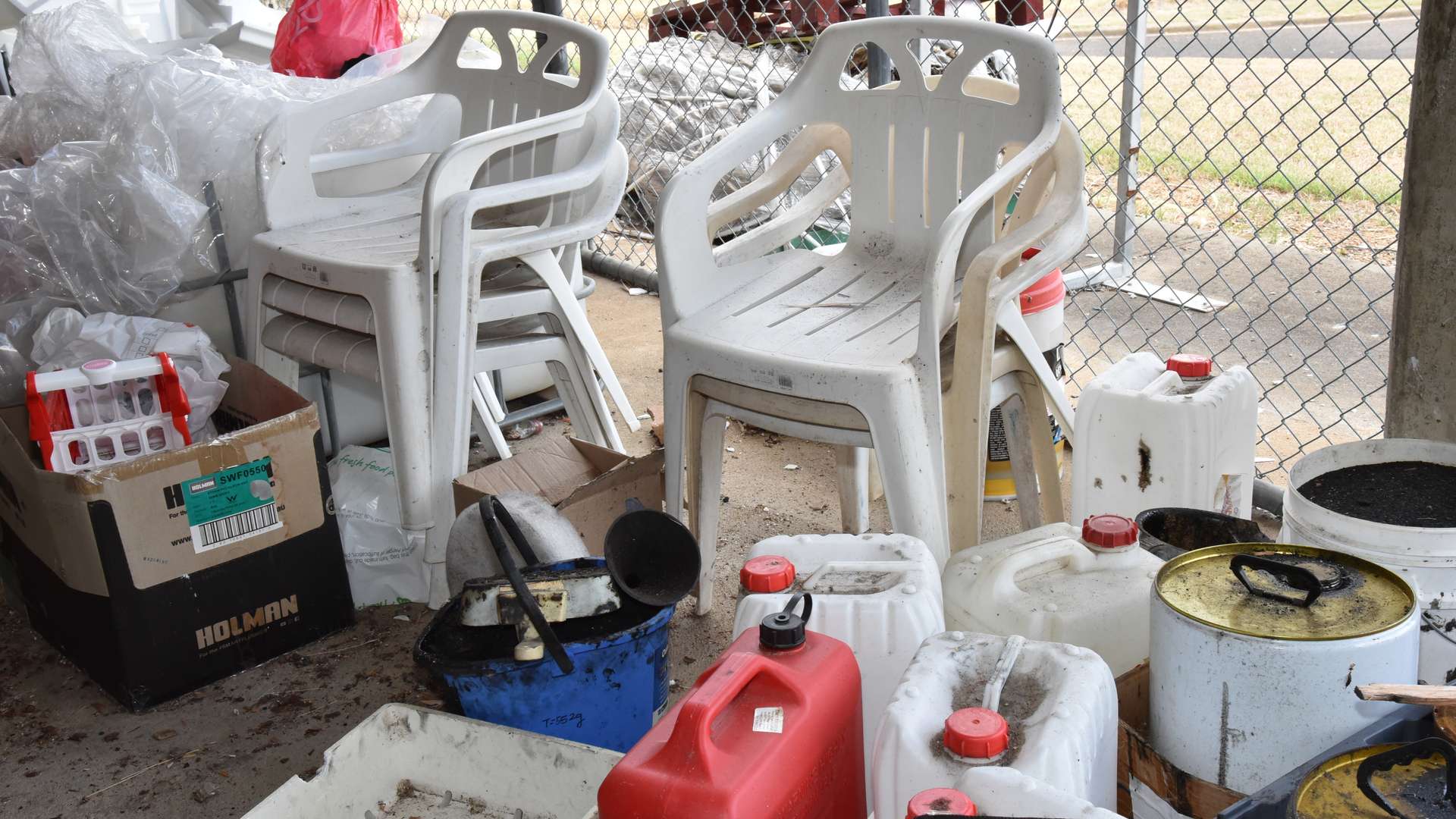 A range of plastics: chairs, bottles, bags in a shed