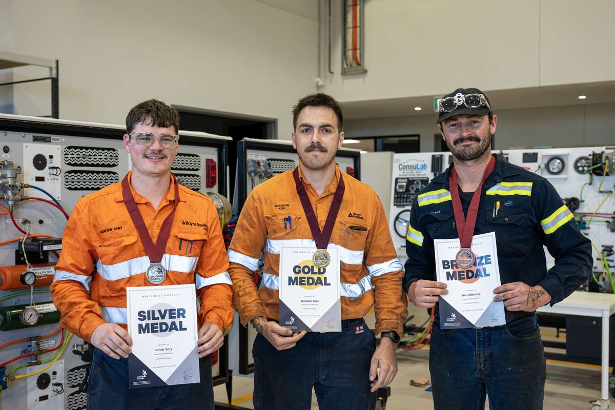 Image of three young men in hight visibility clothing holding certificates